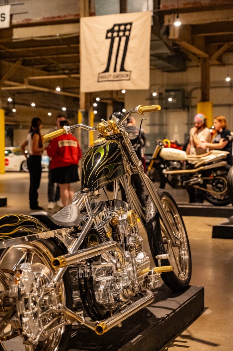 A custom chopper parked against a rustic backdrop, evoking the spirit of the open road and the freedom it represents.